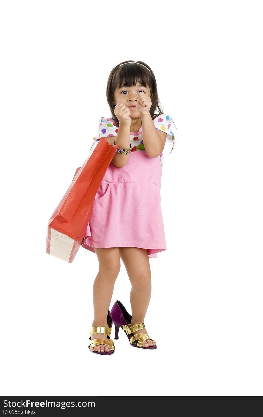 Cute little girl with shopping bag and oversized shoes, isolated on white background. Cute little girl with shopping bag and oversized shoes, isolated on white background