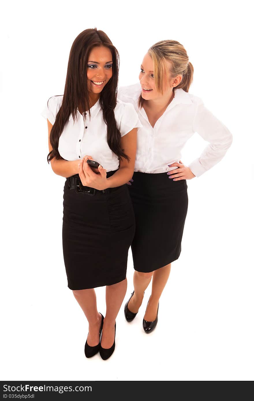 Two Business women in a white shirt and black skirt one showing the other a text message