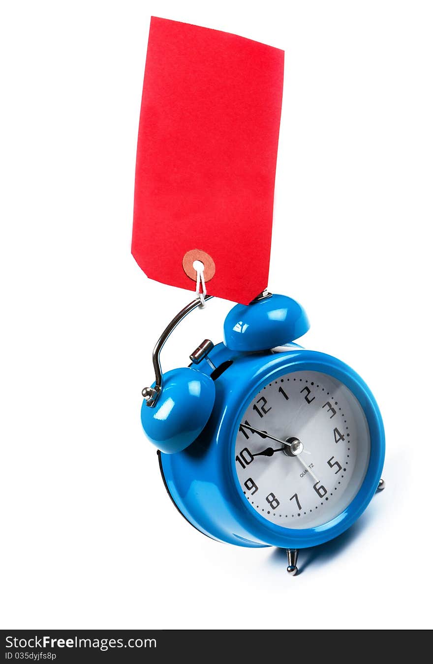 Old Fashioned blue mechanical alarm clock with a red luggage tag. Old Fashioned blue mechanical alarm clock with a red luggage tag