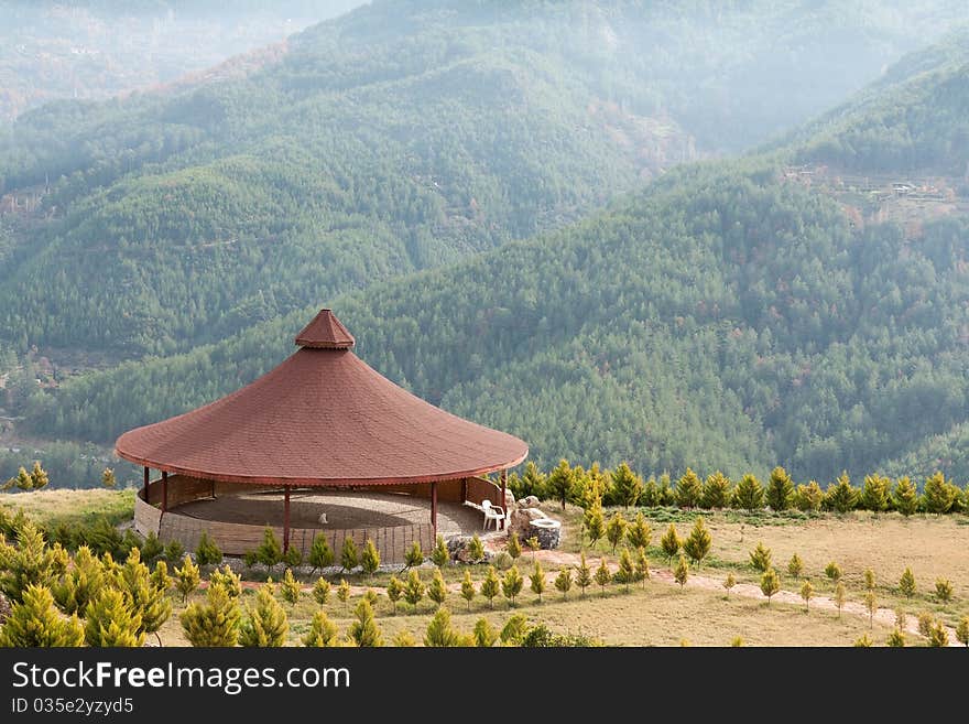 Arbor with a round roof mountains in the background