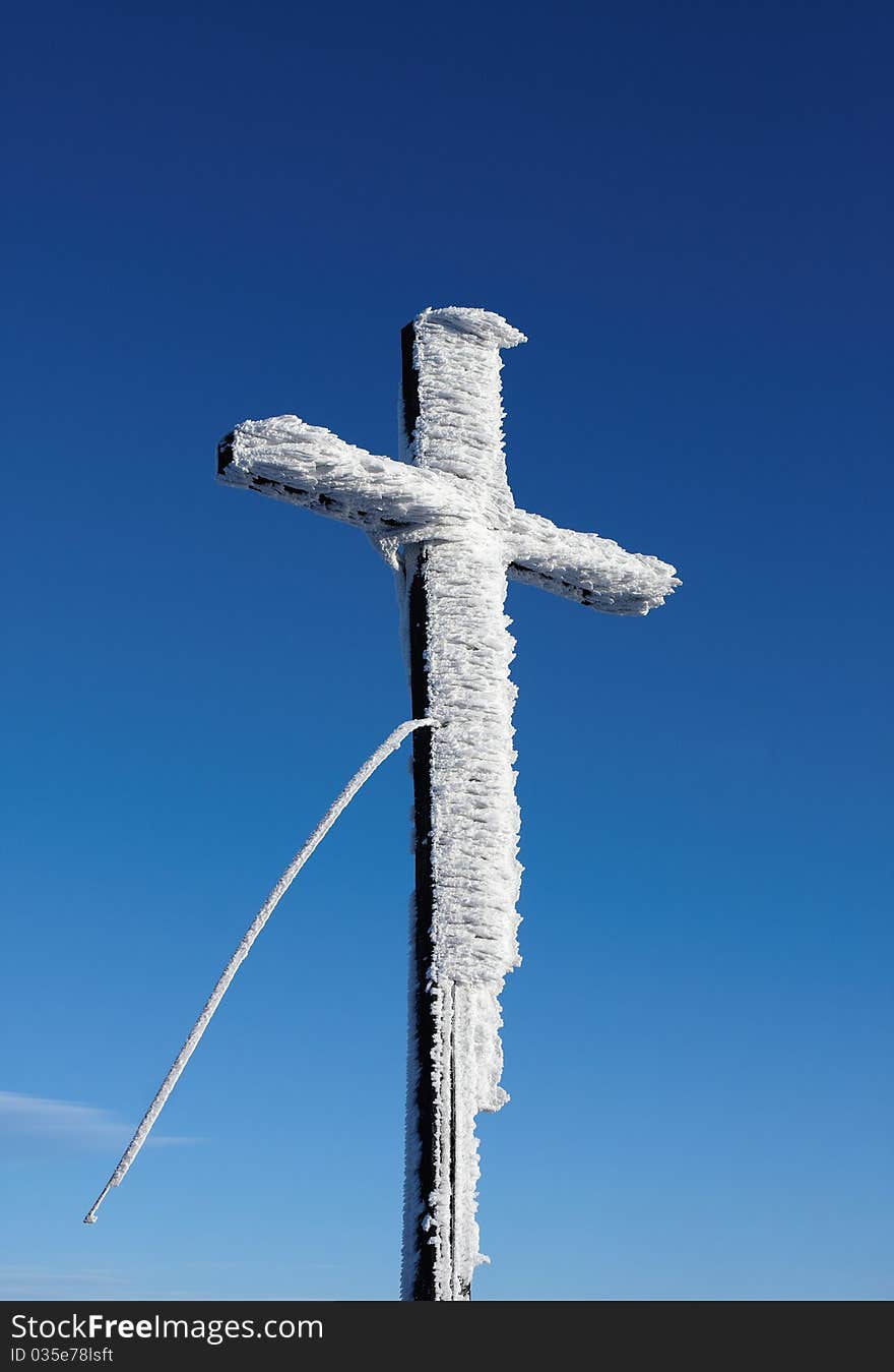 Wooden cross under snow