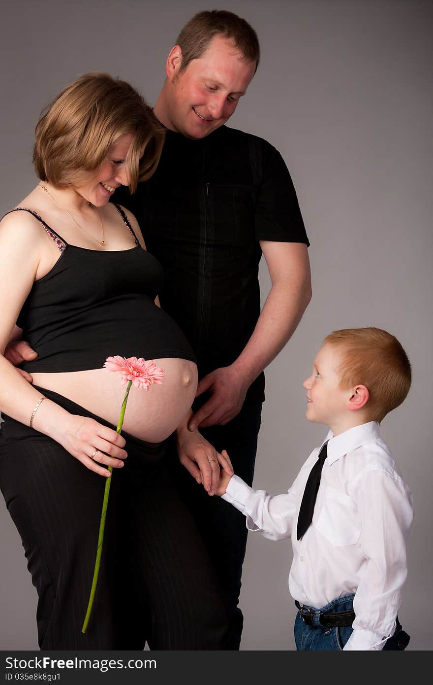 Happy family with cute boy expecting another baby