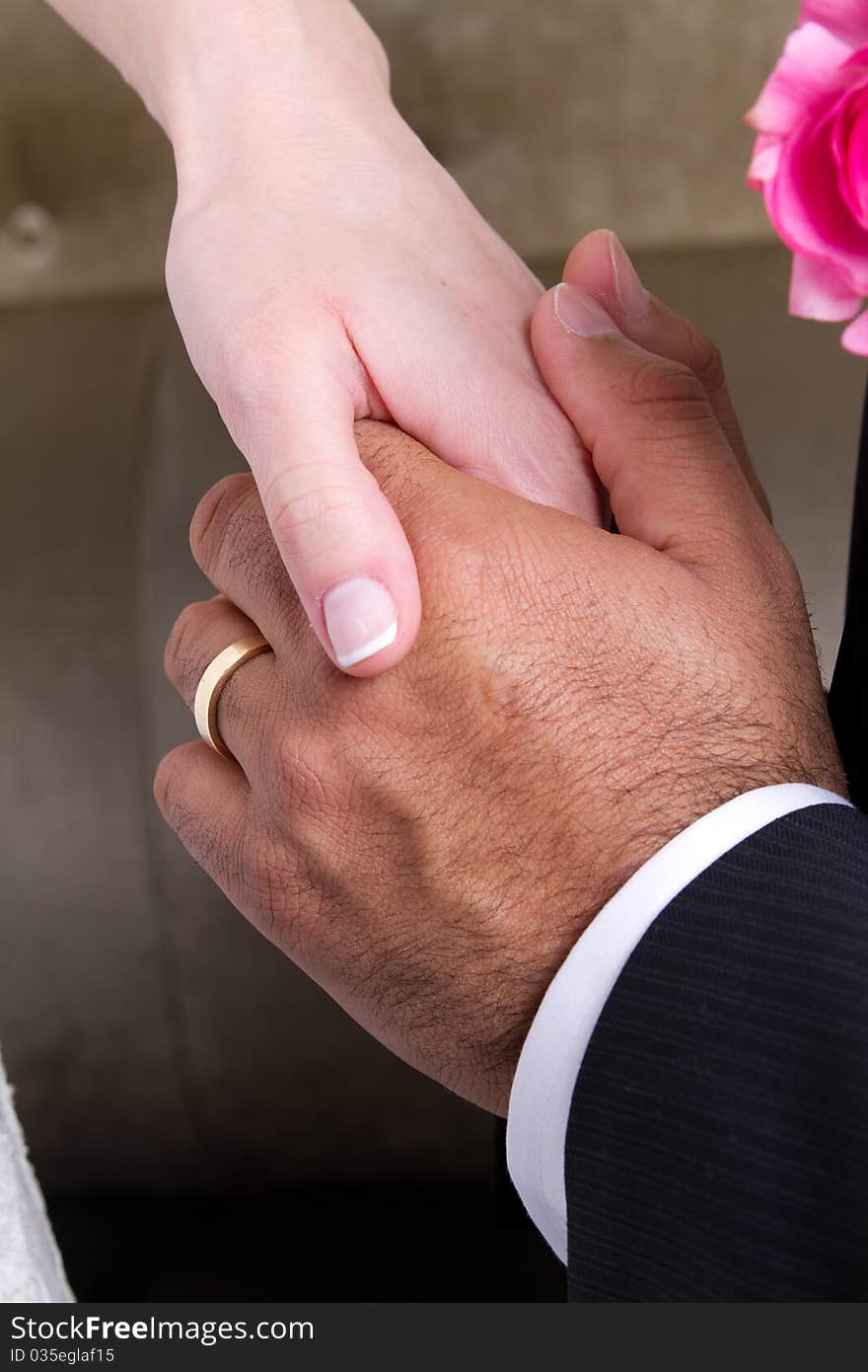 Newly wed couple holding hands and showing their love. Newly wed couple holding hands and showing their love.