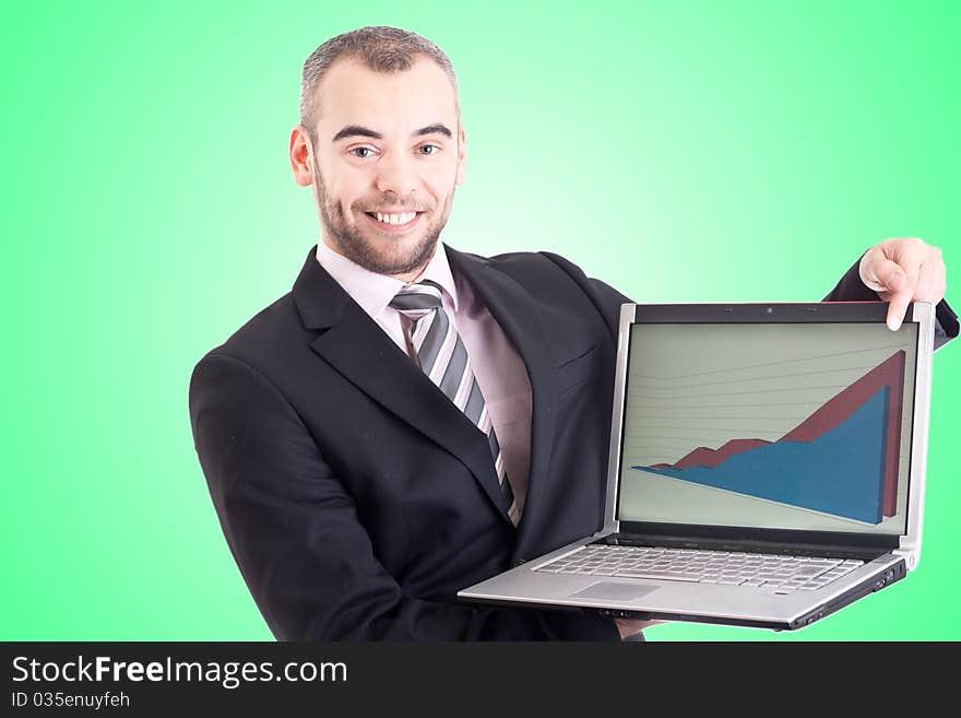 Business man pointing at a laptop with graph with green background