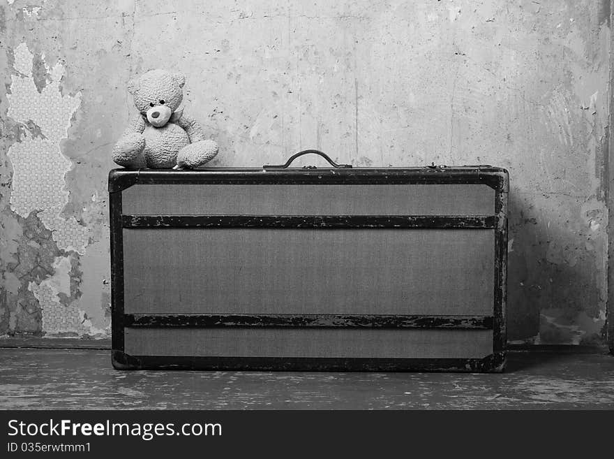 Old suitcase with Teddy