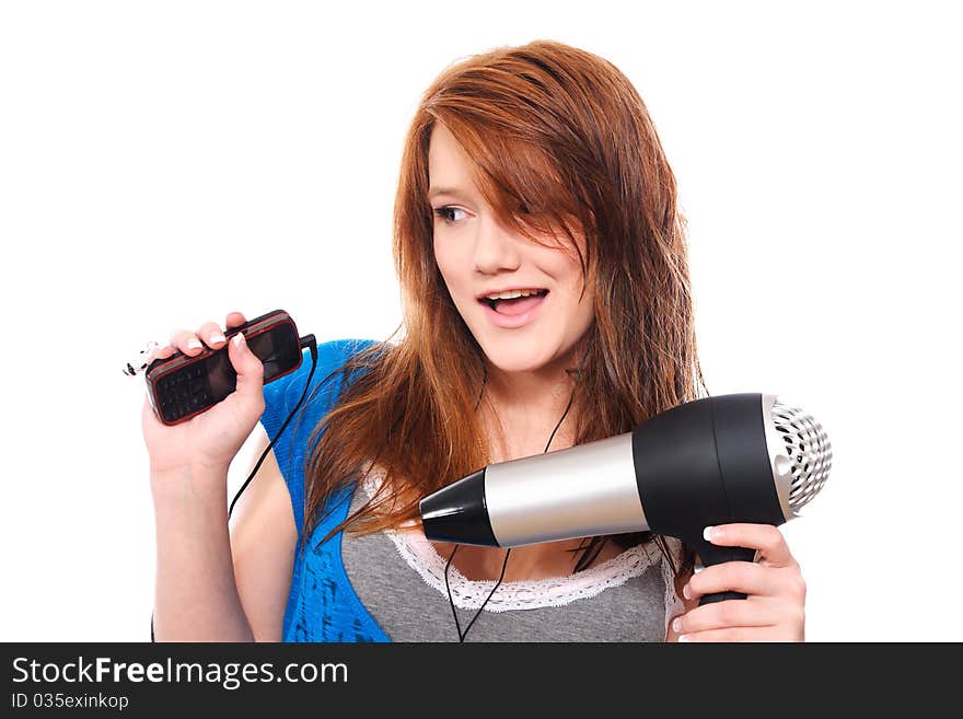 Young woman with fashion hairstyle holding hairdryer and listen to music. Young woman with fashion hairstyle holding hairdryer and listen to music