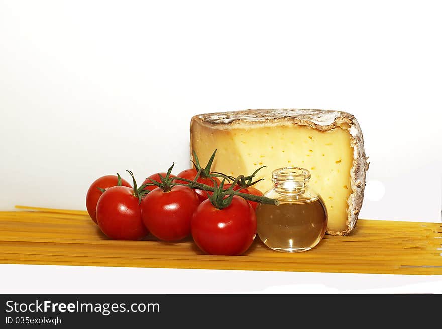 Still life of cheese, tomatoes, olive oil and spaghetti. Still life of cheese, tomatoes, olive oil and spaghetti