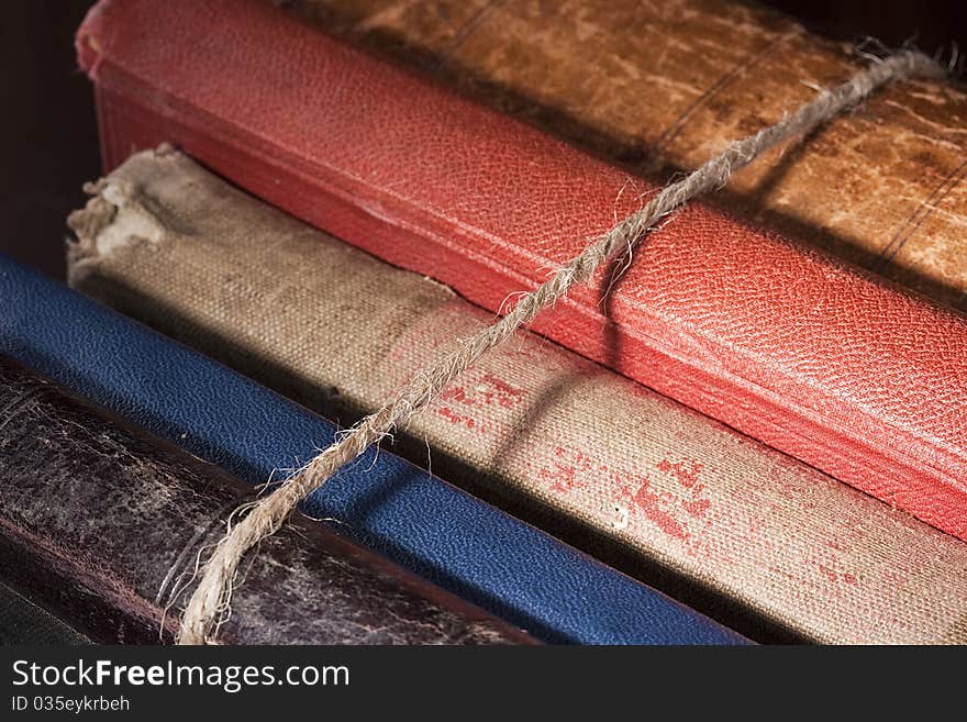 Archival books in a book-depository are tied up by a cord. Archival books in a book-depository are tied up by a cord.