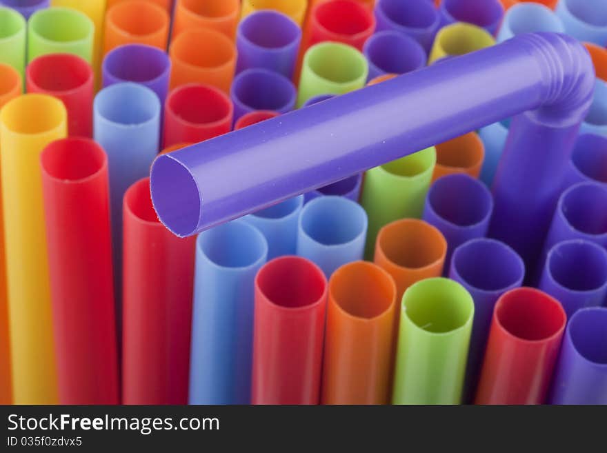 Plastic tubes of different colors in the background.