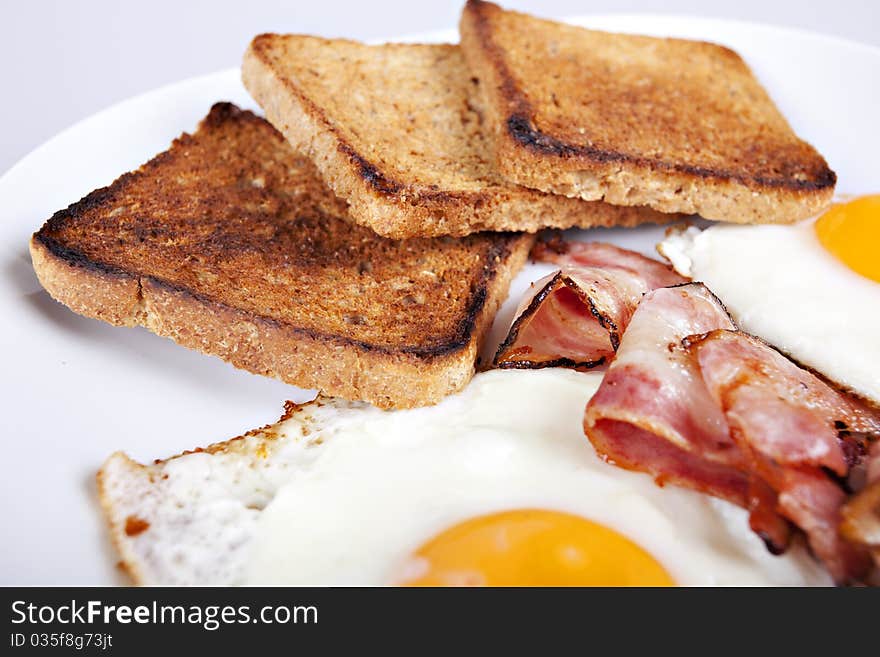 Breakfast - roasted toasts, eggs, bacon. Breakfast - roasted toasts, eggs, bacon