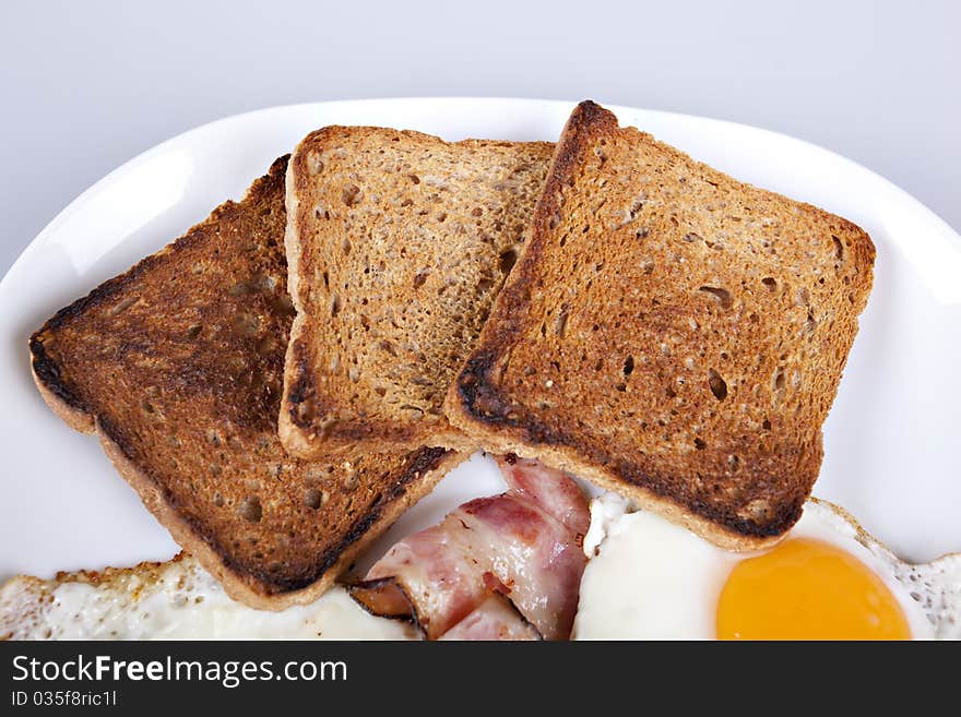 Breakfast - toasts, eggs, bacon