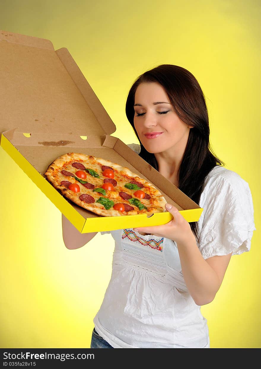 Pretty young casual girl with tasty pizza in delivery paper box. isolated on white background. Pretty young casual girl with tasty pizza in delivery paper box. isolated on white background