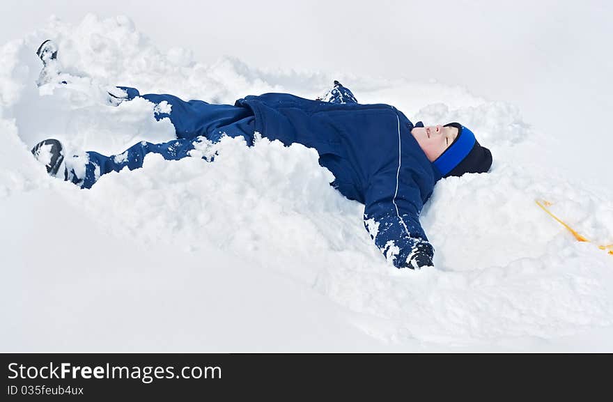 Boy laying in the snow