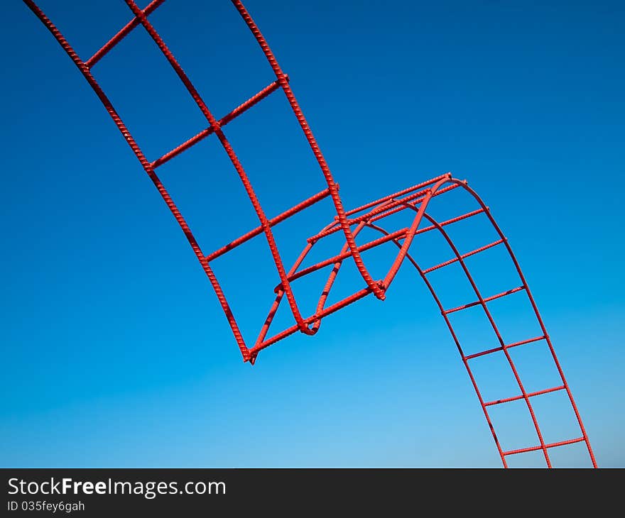 Bending steel painted red and blue sky background