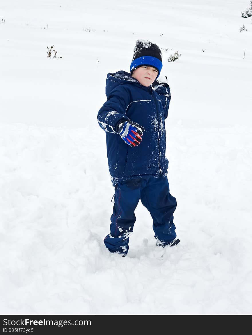 Little boy throwing a snowball. Little boy throwing a snowball