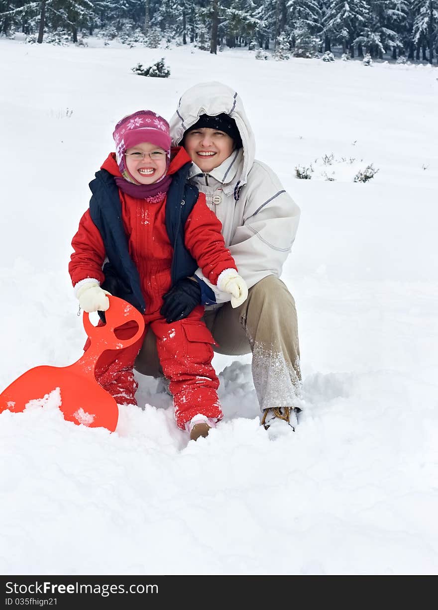 Happy woman with her daughter in winter time