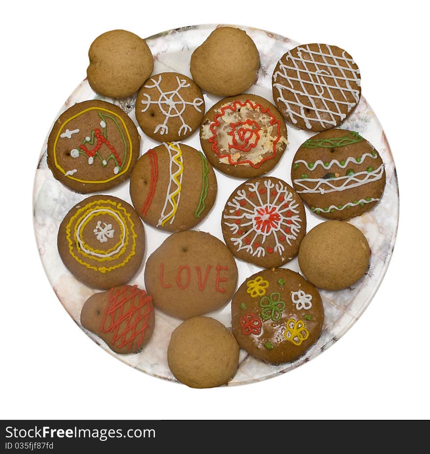 Cookies painted manually on plate isolated on white