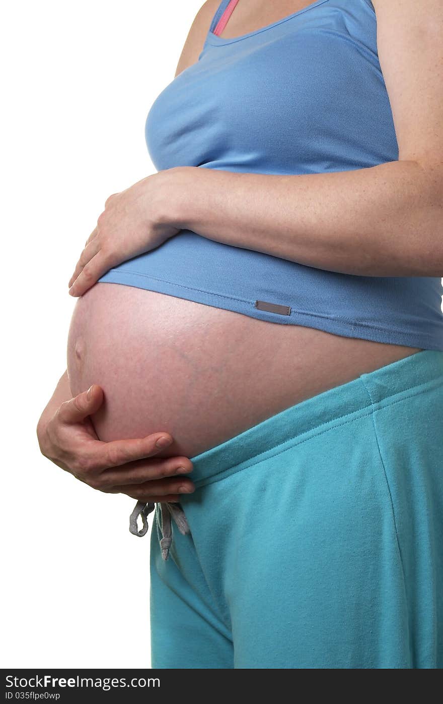 Pregnant woman profile with hands on the stomach over white background. Pregnant woman profile with hands on the stomach over white background