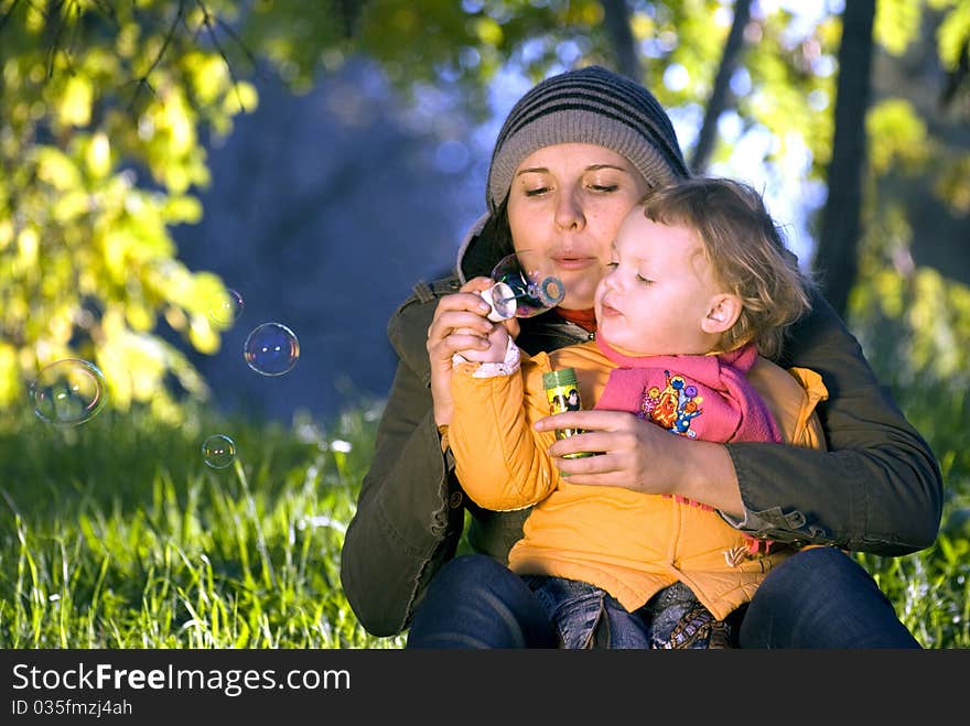 Mother and daughter playing outdoors. Mother and daughter playing outdoors