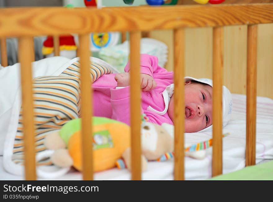 Little girl sleeping in cot