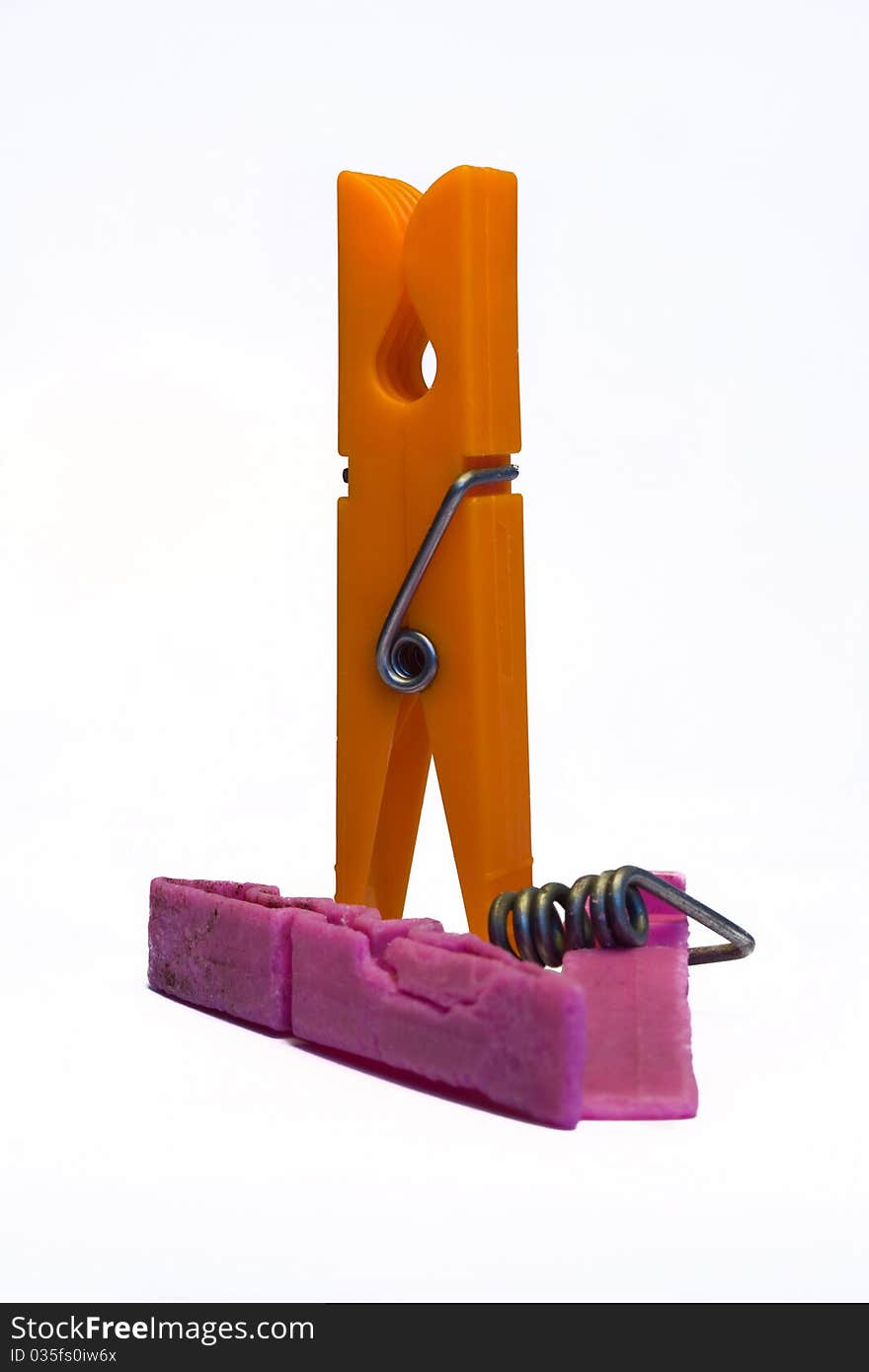 One broken clothespin and one orange clothespin isolated. One broken clothespin and one orange clothespin isolated