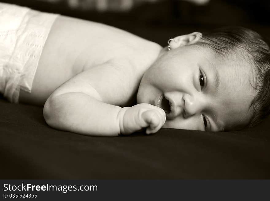 Portrait with little baby girl on black background