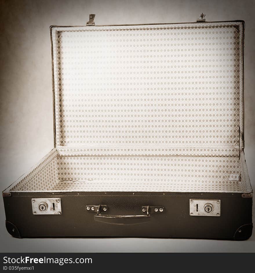 Vintage suitcase - opened - on white background in sepia