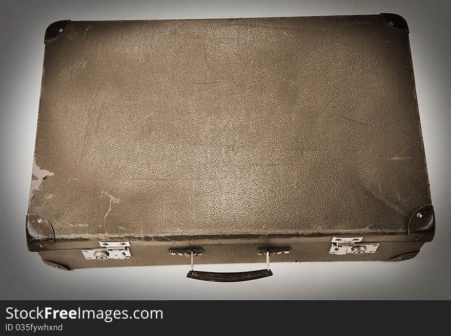 Vintage suitcase in sepia on white background