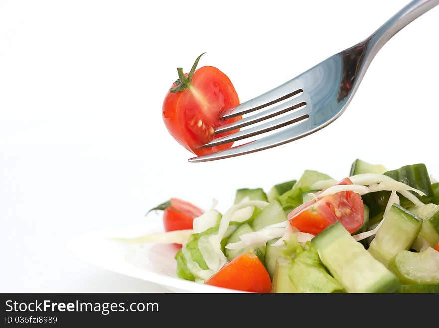 Tomato cherry and fork on white background. Tomato cherry and fork on white background.