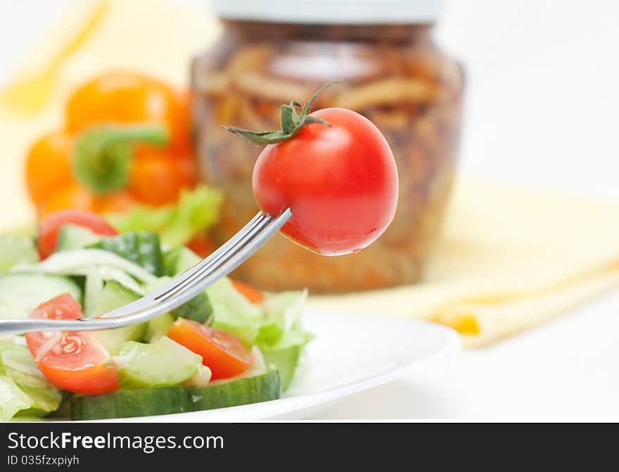 Tomato cherry and fork on white background. Tomato cherry and fork on white background.