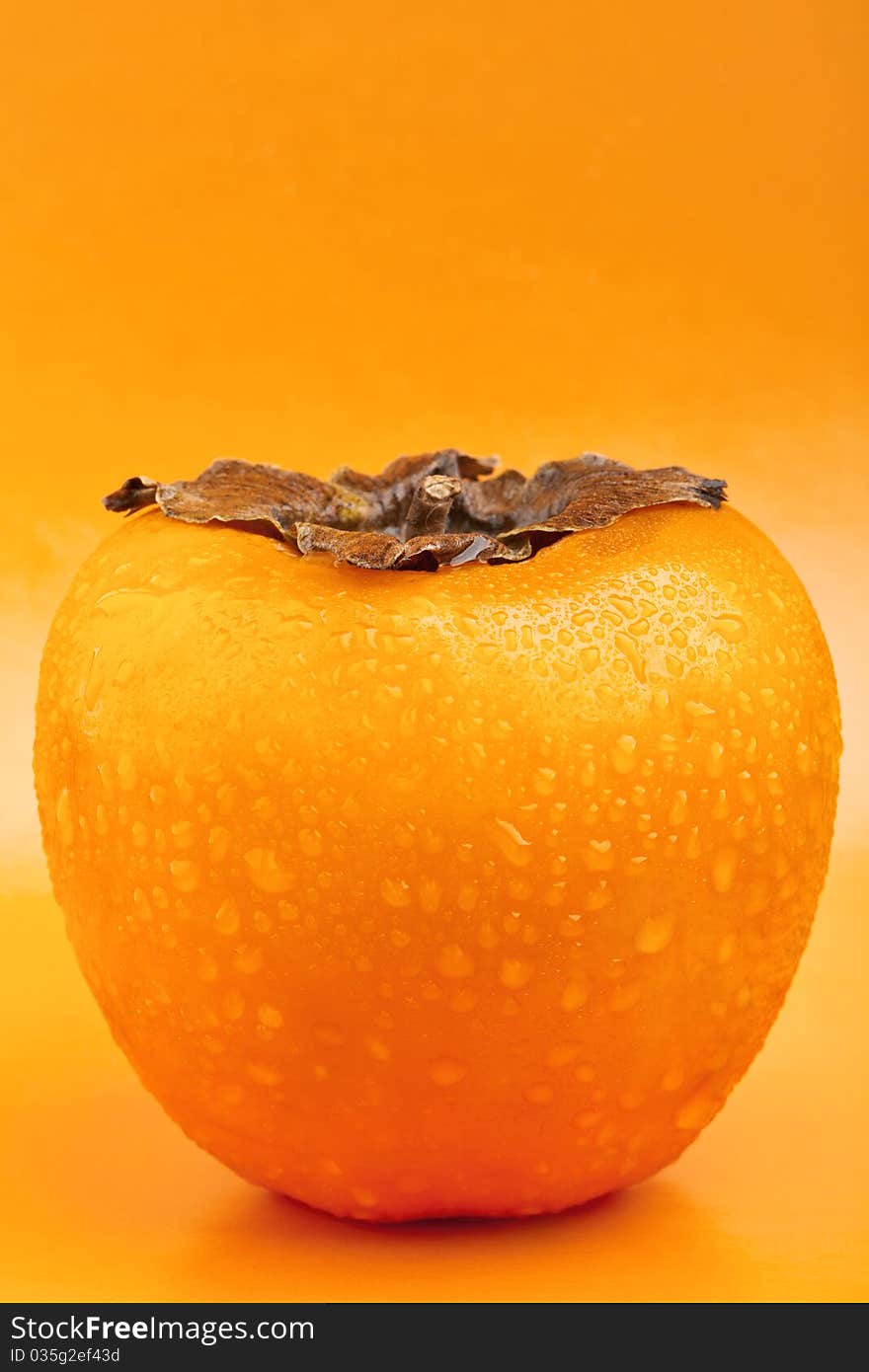 Persimmon fruit with drops of water