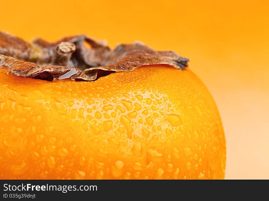 Persimmon fruit with drops of water