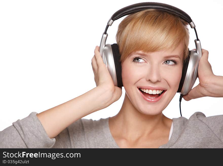 Closeup of a pretty blond female listening to music over headphones. Closeup of a pretty blond female listening to music over headphones