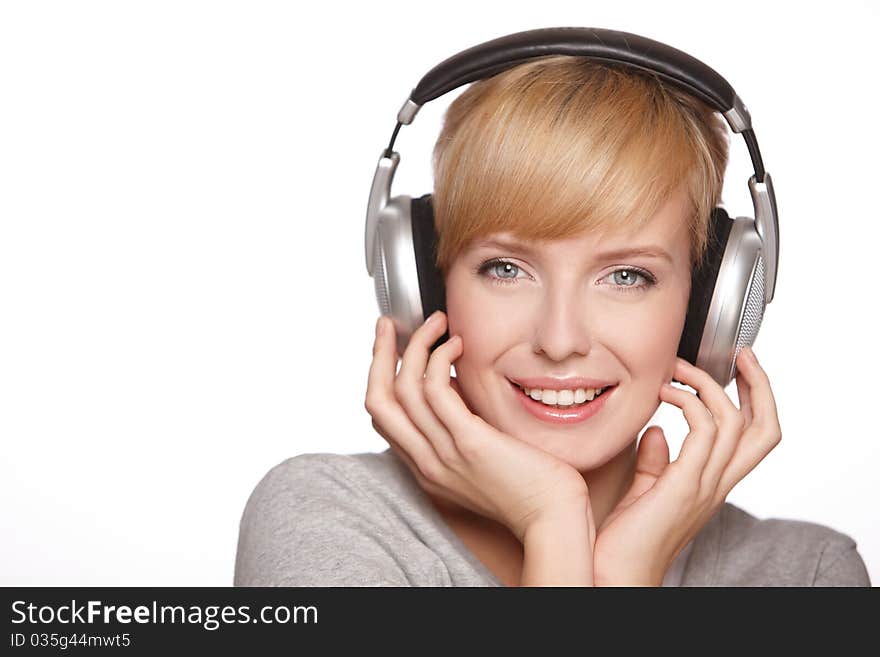 Closeup of a pretty blond female listening to music over headphones. Closeup of a pretty blond female listening to music over headphones