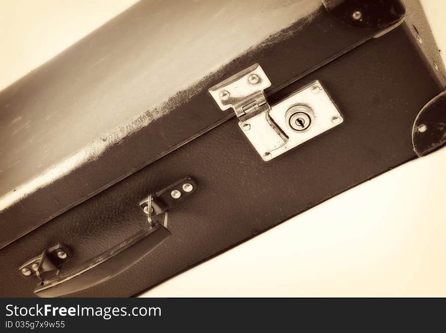 Vintage suitcase in sepia on white background