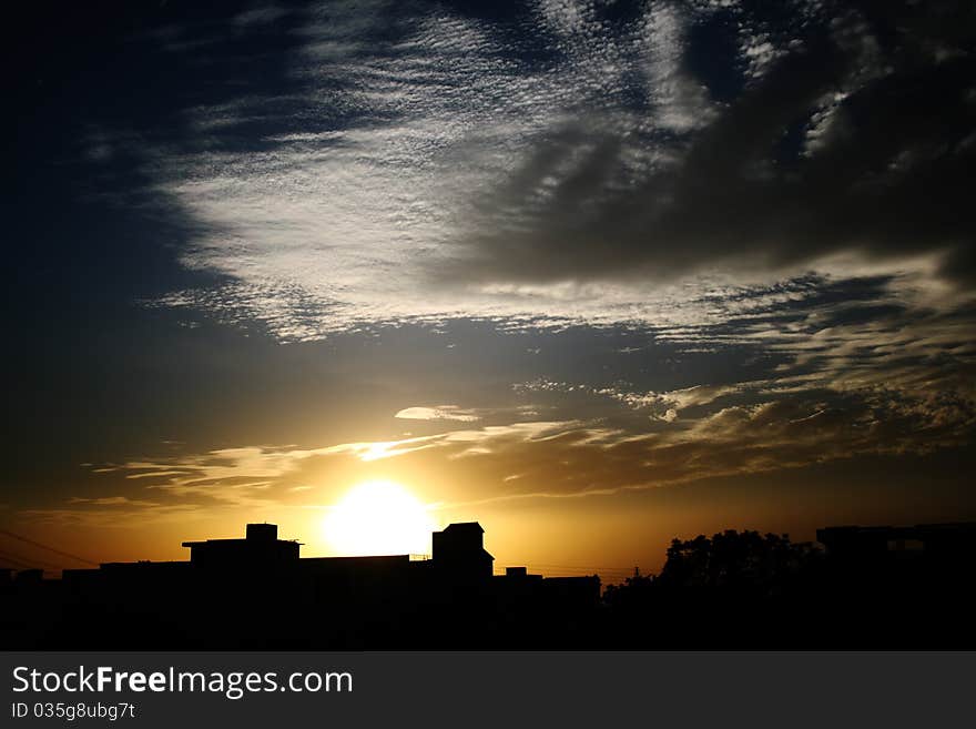 Cloudscape sunset behind silhouette Cityscape