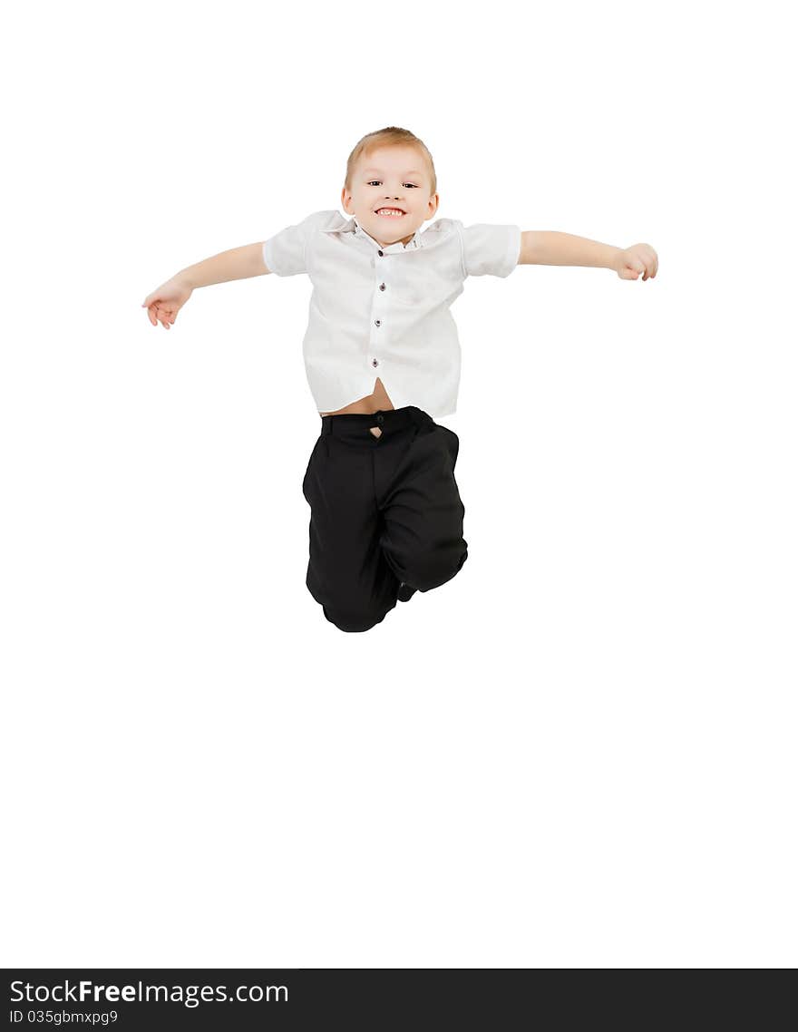 Adorable child jumping proudly a over white background