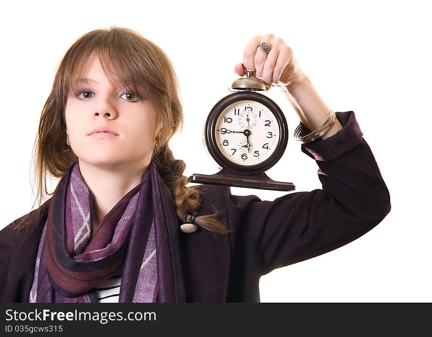 Teenage girl with old alarm clock