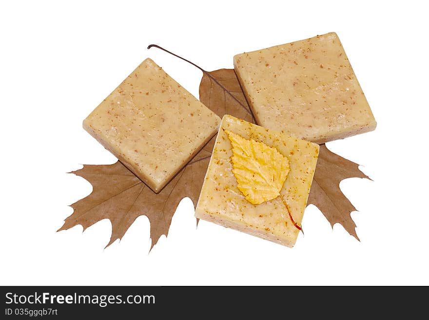 Three bars of natural soap with leaves on a white. Three bars of natural soap with leaves on a white