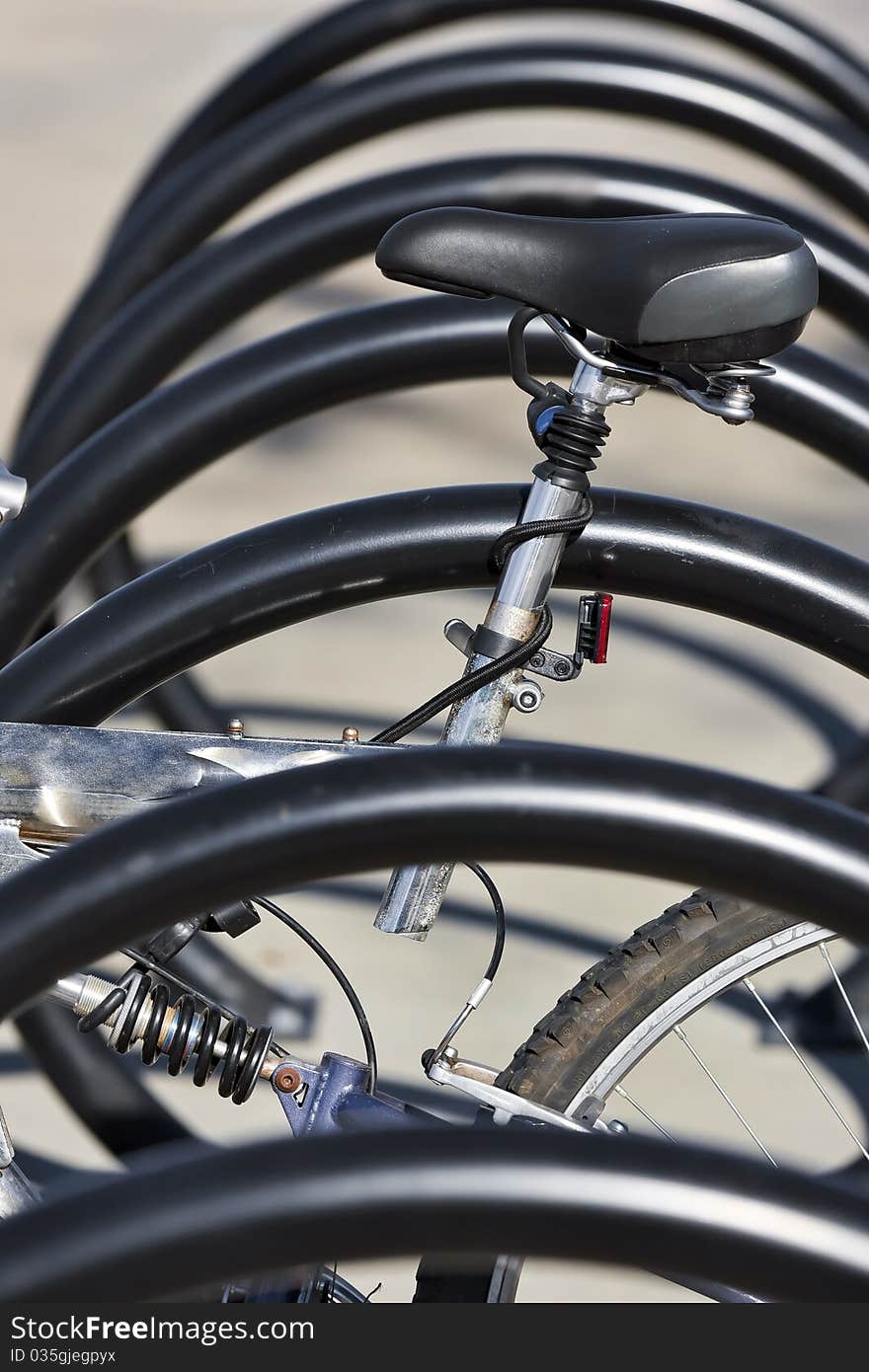 A bicycle sits in a bicycle rack