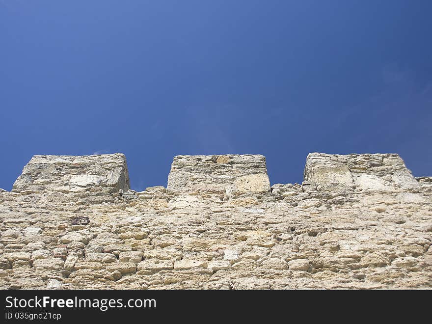 Merlons of an old fortress wall in a sunny day