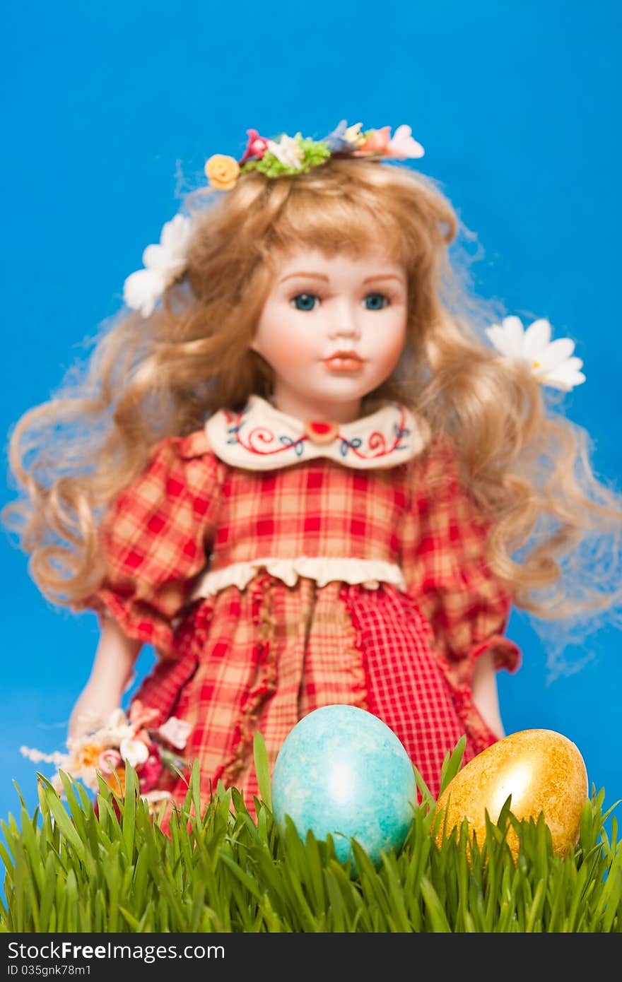 Doll with easter eggs, focus on a foreground