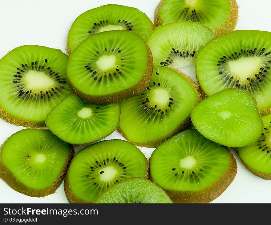 Sliced kiwi fruit on white