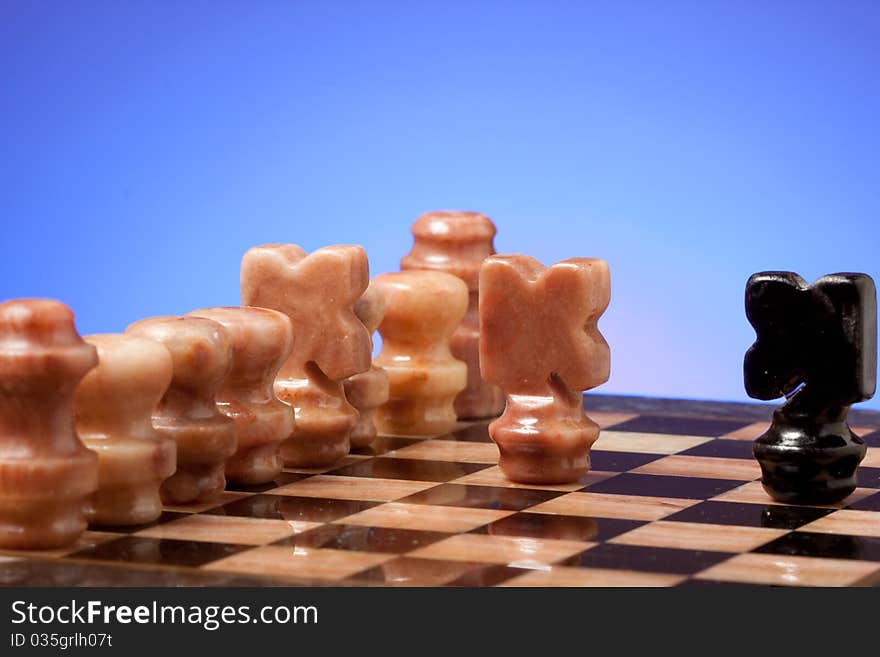 Marble chess on chessboard with light blue background