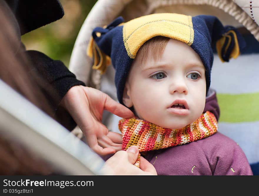 Pretty 1 year old boy in warm clothes outdoors. Pretty 1 year old boy in warm clothes outdoors