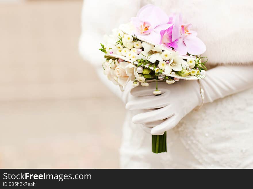 Hands of bride holding beautiful boquet with violet orchids. Hands of bride holding beautiful boquet with violet orchids