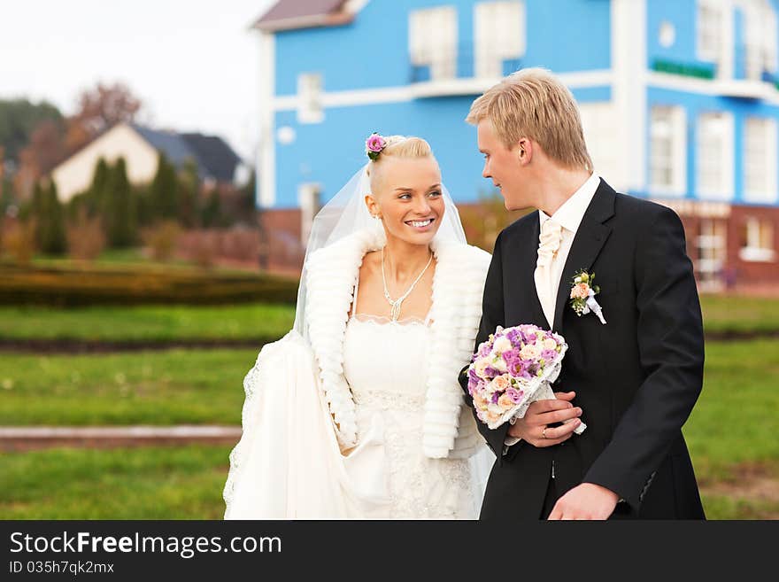 Beautiful just married caucasian couple walking and smiling. Beautiful just married caucasian couple walking and smiling