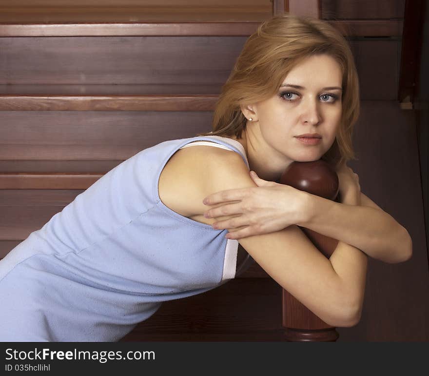 Portrait beautiful blonde on a wooden ladder