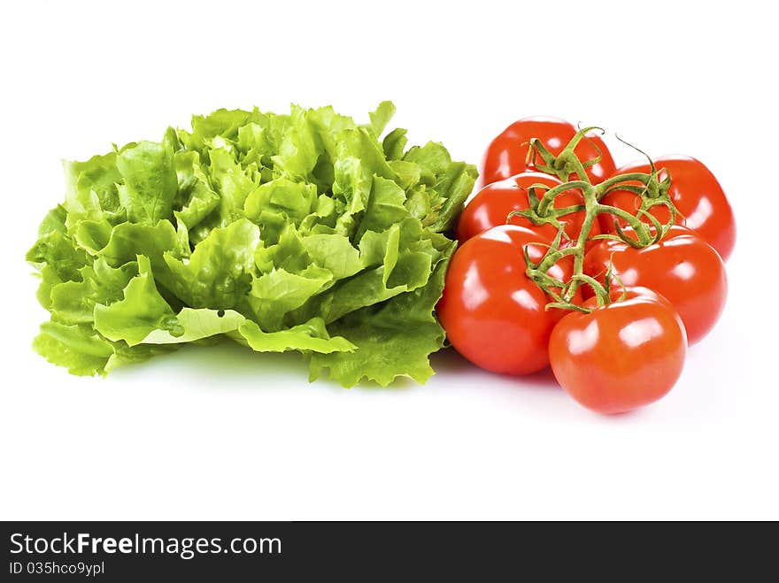 Fresh tomatoes and lettuce isolated over white background