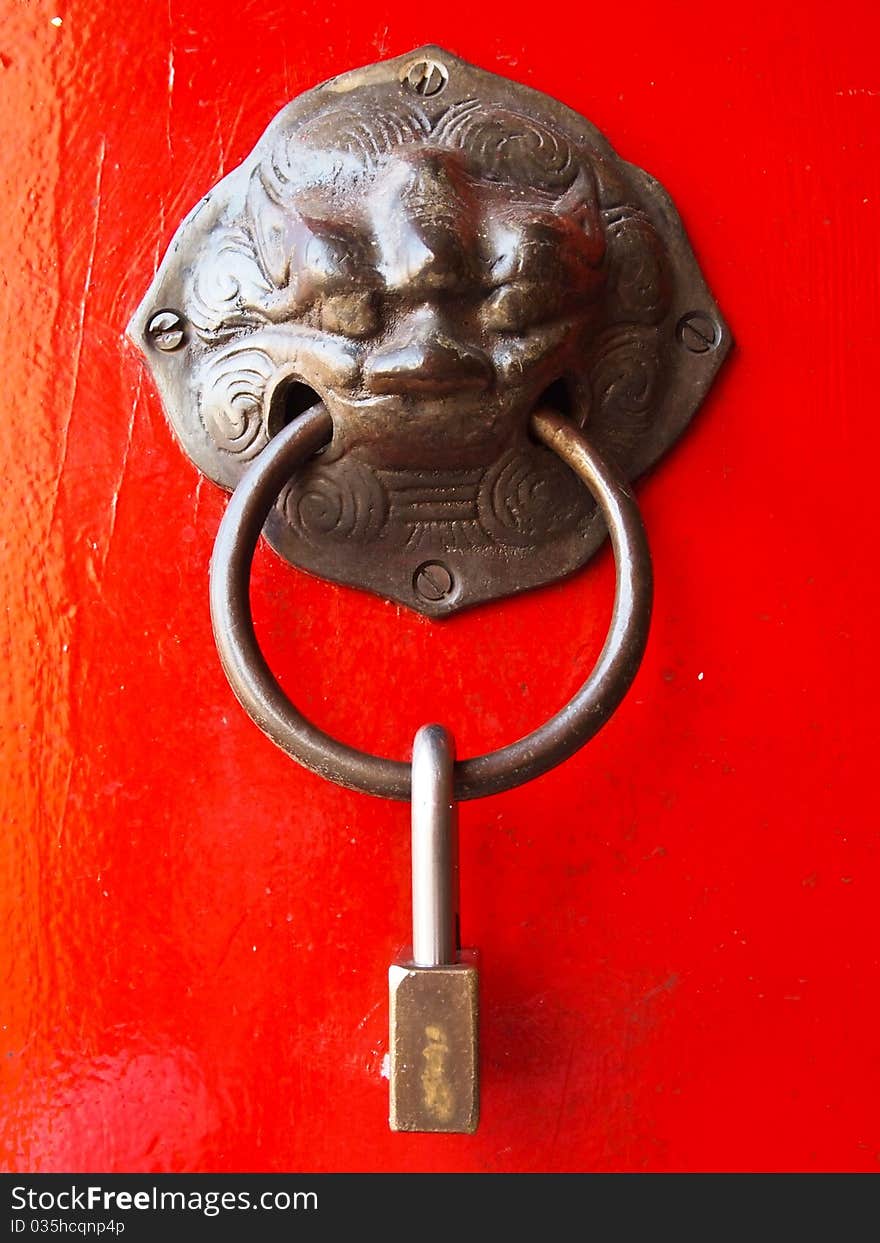 Red chinese door with a lion head